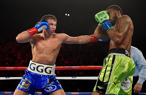 Gennady Golovkin, left, of Kazakhstan, connects with Dominic Wade during a middleweight title boxing match. |AP