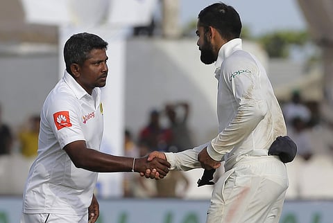 India's captain Virat Kohli, right, shakes hands with Sri Lankan captain Rangana Herath after their win in the first test cricket match. | AP