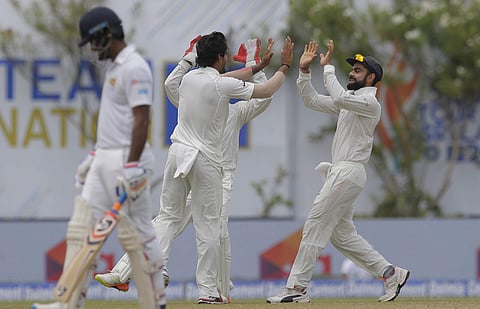 India's bowler Umesh Yadav, second from left, is congratulated by Virat Kohli, right, for taking the wicket of Sri Lanka's batsman Dhanushka Gunatilaka during the fourth day's play | AP