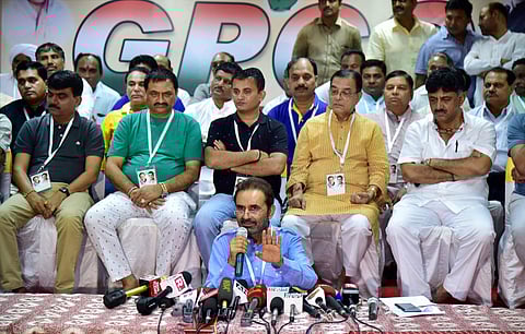 Congress Spokesperson Shakti Singh Gohil speaks as Gujarat Congress MLAs seen behind him during a press conference at a resort on the outskirts of Bengaluru on Sunday. | PTI