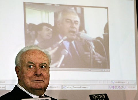 FILE - In this Nov. 7, 2005 file photo, former Australian Prime Minister Gough Whitlam watches as a film clip of his resignation speech plays behind him during a lunch in Sydney, Australia. Historian, Professor Jenny Hocking, is going to court in July, 20