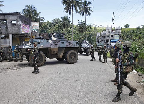 FILE - In this Tuesday, May 30, 2017, file photo, government troops head to the frontline as fighting with Muslim militants in Marawi city enters its second week in southern Philippines. Philippine troops have captured a key bridge leading to the main pos