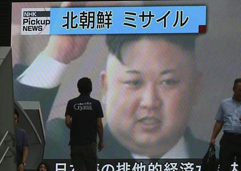 People walk past a TV news on screen showing an image of North Korean leader Kim Jong Un while reporting North Korea's missile test which landed in the waters of Japan's economic zone in Tokyo Tuesday, July 4, 2017. (File | AP)
