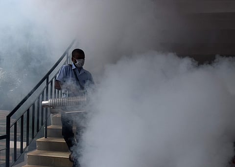 A man carries out mosquito fogging at Delhi Public School on Kanakapura Road on Wednesday | Vinod Kumar T