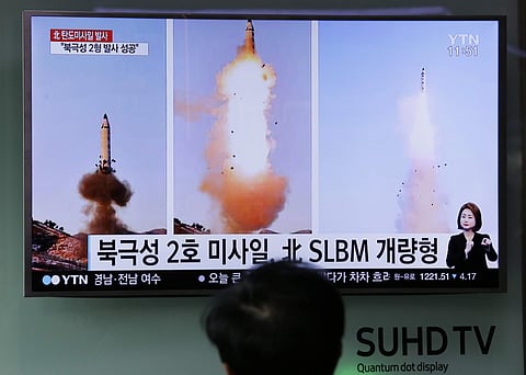 A man watches a TV news programme showing photos published in North Korea's Rodong Sinmun newspaper of North Korea's 'Pukguksong-2' missile launch. (Photo | AP)