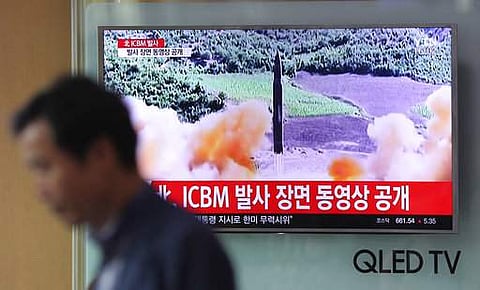 A man walks by a TV screen showing a local news program reporting about North Korea's missile firing at Seoul Train Station in Seoul, South Korea, Wednesday, July 5, 2017. (AP)