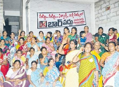 Women staging a protest at Bhanu Nagar in Vijayawada on Wednesday against setting up of a liquor shop | Express