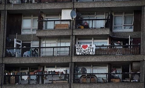A banner hangs from a balcony near the Grenfell apartment tower block in North Kensington in London, Britain July 5, 2017. (Photo | Reuters)