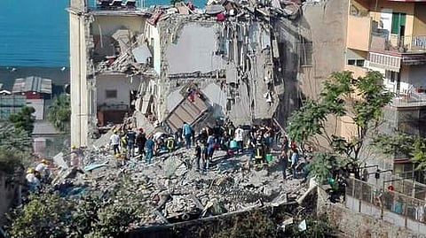 Rescuers work amid the rubble of a building that collapsed in Torre Annunziata, near Naples, southern Italy, Friday, July 7, 2017. A five-story apartment block collapsed early Friday near the southern Italian city of Naples, and authorities were digging b