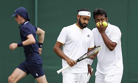 India's Leander Paes (R) and his partner Canada's Adil Shamasdin (L) confer between points against Austria's Julian Knowle and Philipp Oswald during their men's doubles first round match on the fourth day of the 2017 Wimbledon Championships. | AFP