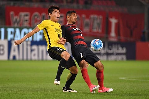 Guangzhou Evergrande skipper Zheng Zhi (L)| AFP