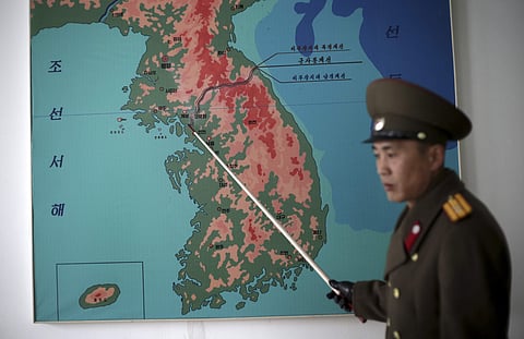Korean People's Army Lt. Col. Nam Dong Ho points to a map showing the line that separates the two Koreas in Panmunjom at the Demilitarized Zone (DMZ) on Monday in Panmunjom, North Korea. (File | Associated Press)