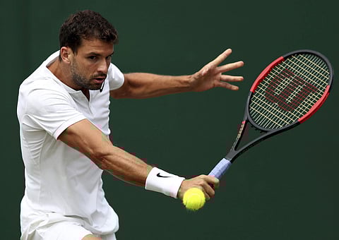 Bulgaria's Grigor Dimitrov returns to Israel's Dudi Sela during their Men's Singles Match on day six at the Wimbledon. | AP