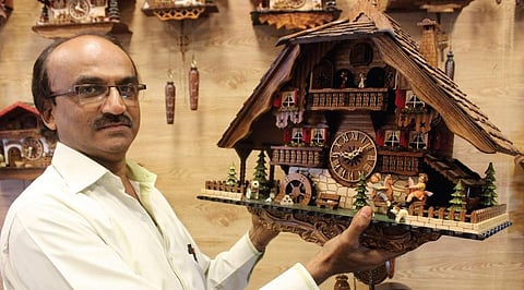 Pankaj Parekh, owner of Kismet Watch Company, showing a cuckoo clock in his shop | s manjunath