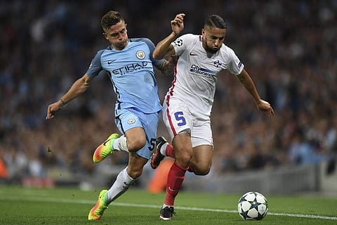 Steaua Bucharest's Algerian midfielder Jugurtha Hamroun (R) holds off a challenge from Manchester City's Spanish defender Pablo Maffeo (L) | AFP