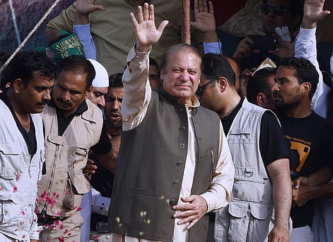 Deposed Pakistani Prime Minister Nawaz Sharif waves to his supporters while he arrives to address a rally in Gujrat, Pakistan (AP)