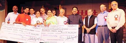 Governor Ch Vidyasagar Rao presenting cheque to Muscular Dystrophy Association of India members and environmentalist Arun Krishnamurthy during the 18th anniversary celebrations of Samruddhi Foundation in Chennai on Saturday, as Sudha Ragunathan, political