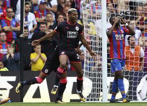 Huddersfield Town's Steve Mounie, left, celebrates scoring his side's second goal against Crystal Palace during the English Premier League soccer match at Selhurst Park. | AP