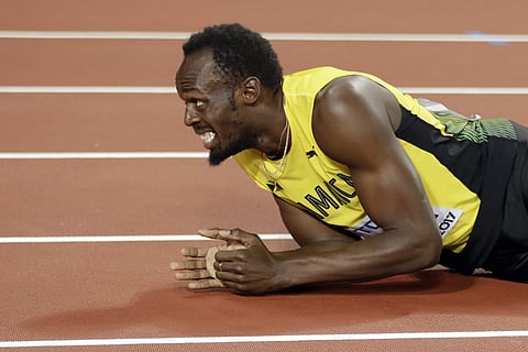 Jamaica's Usain Bolt lies on the track after injuring himself during the men's 4x100m final at the World Athletics Championships in London. | AP
