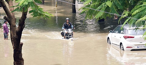 LIFE in a metro: While many people were forced to stay indoors, a food delivery man braves a flooded road in BED Layout in Koramangala on Tuesday | Nagaraja Gadekal