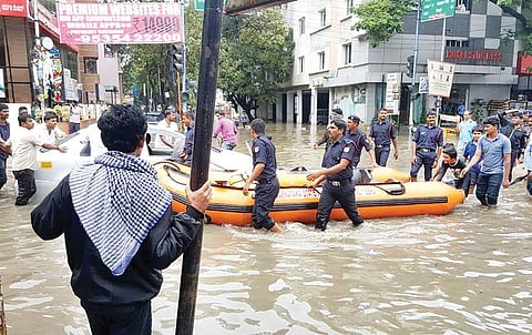 State disaster relief personnel using an inflatable boat to rescue residents at ST Bed Layout in Koramangala in Bengaluru after heavy rainfall inundated the locality on Tuesday | Express
