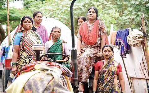 Chitra (second from right) with her neighbours who took shelter from the flood on a parked tractor for nearly seven hours, in ST Bed Layout in Koramangala on Tuesday | Nagaraja Gadekal