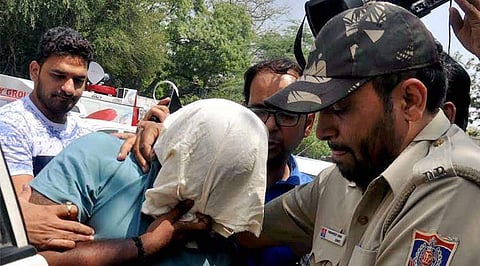 Officials of Delhi Police Crime Branch escort Sukesh Chandrashekar. (File photo | PTI)