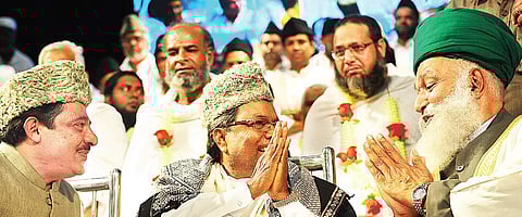 Chamarajpet MLA Zameer Ahmed Khan and Chief Minister Siddaramaiah at programme to felicitate Haj pilgrims at Town hall in Bengaluru on Friday | NAGESH POLALI