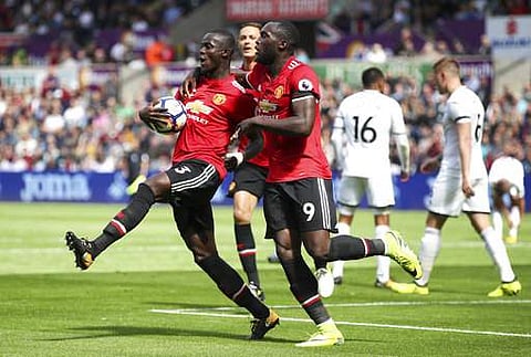 Manchester United's Eric Bailly, left, celebrates with teammate Romelu Lukaku after scoring his side's first goal during their English Premier League soccer match at the Liberty Stadium, Swansea, Wales, Saturday, Aug. 19, 2017. | AP