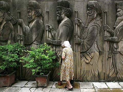 A Parsi women praying near a fire temple at Tardeo in Mumbai, during Navroz, the Parsi New Year (Photo | AP)