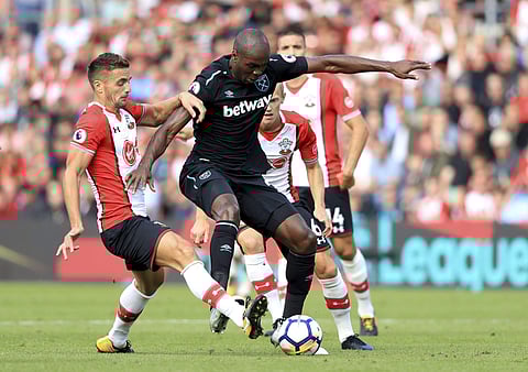 Southampton's Dusan Tadic, left and West Ham United's Angelo Ogbonna battle for the ball, during the English Premier League soccer match between Southampton and West Ham. | AP