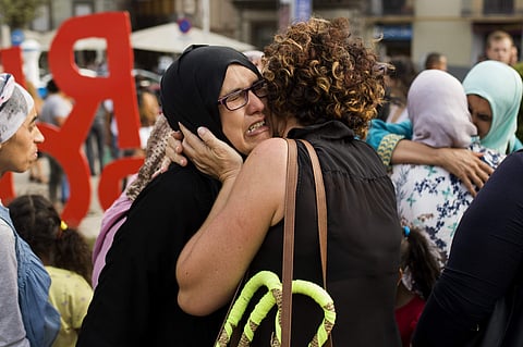 Families of young men believed responsible for the attacks in Barcelona and Cambrils gather along with members of the local Muslim community to denounce terrorism and show their grief in Ripoll, north of Barcelona (AP)