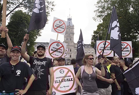 Tensions boiled over in Quebec City on Sunday, as police were pelted by beer bottles and smoke bombs set off in garbage cans (AP)