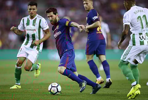 FC Barcelona's Lionel Messi, second left, in action during the Spanish La Liga soccer match between FC Barcelona and Betis at the Camp Nou stadium in Barcelona. | AP