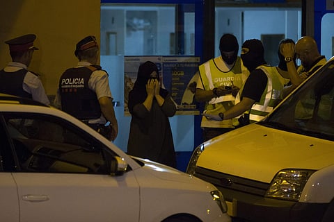 Police block the entrance of a telephone call centre as they search the premises in Ripoll, Spain, Tuesday Aug. 22, 2017. | AP