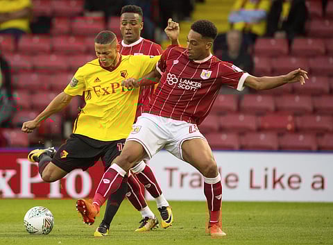 Watford's Richarlison, left, and Bristol City's Zak Vyner battle for the ball during the League Cup second round soccer match at Vicarage Road. | AP