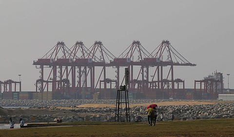In this Tuesday, March 15, 2016, file photo, a Sri Lankan couple walk on the Galle Face green as the China Port City project is seen behind in Colombo, Sri Lanka. | AP