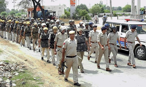 Police personnel conduct a flag march in Hisar on Wednesday. | PTI