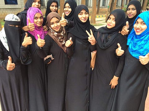 Muslim women flashing victory sign at a college after Supreme Court announced a ban on triple talaq in Bengaluru on Tuesday. | (Nagaraj Gadekal | EPS)