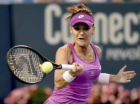 Poland's Agnieszka Radwanska returns a volley to Peng Shuai, of China, in the quarterfinals of the Connecticut Tennis Open in New Haven. | AP