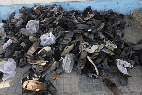 Shoes of victims of an attack are gathered inside the Shiite mosque attacked (AP)