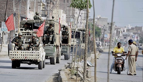 Army personnel conduct a flag march after their deployment near Dera Sacha Sauda in Sirsa on Saturday following violence triggered by the conviction of Dera Sacha Sauda head Gurmeet Ram Rahim Singh in a rape case on Friday. | PTI