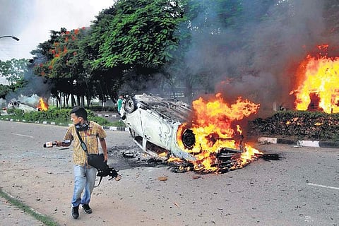 A car burnt by protesting followers of Ram Rahim in Haryana