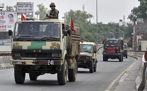 Army jawans conduct a flag march amidst curfew after their deployment near Dera Sacha Sauda in Sirsa on Saturday. | PTI