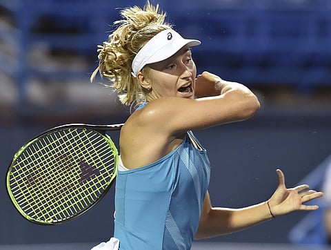 Daria Gavrilova, of Australia, follows through on a return to Poland's Agnieszka Radwanska in the semifinals of the Connecticut Open tennis tournament. | AP