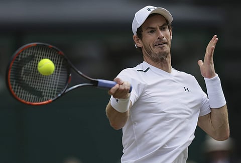 FILE - This July 12, 2017 file photo shows Britain's Andy Murray returning to Sam Querrey of the United States during their Men's Singles Quarterfinal Match at the Wimbledon Tennis Championships in London. | AP