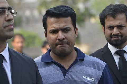 Suspended Pakistani cricketer Sharjeel Khan (C) leaves with his lawyers after appearing before a tribunal in Lahore (File | AFP)