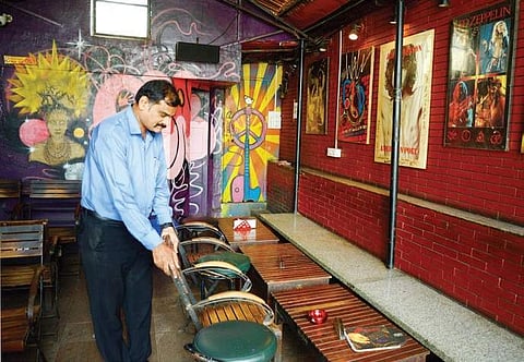 A staffer arranges chairs at Pecos near Brigade Road as the iconic pub is set to reopen after the Supreme Court clarified on its liquor ban order | Pushkar V