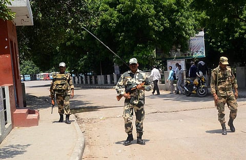 Personnel of Para-Military force patrol a street of in Rohtak on Sunday. | PTI
