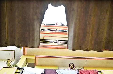 Residents of the building from where the child was allegedly thrown look on.